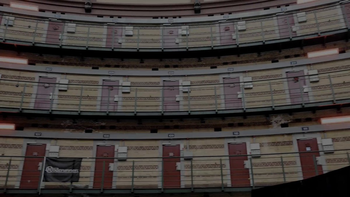 Still from the Noderunners Conference 2026 aftermovie: the cell-block galleries of the Koepelgevangenis